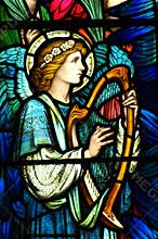 An angel making music in stained glass