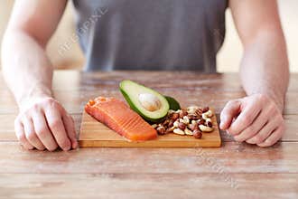 Close up of male hands with food rich in protein