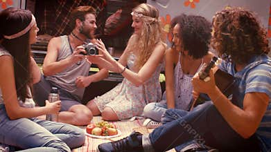 In high quality format hipster friends by camper van at festival