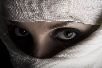 Woman with shawl on face