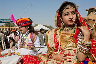 Girl with gold jewelry and traditional dress of India