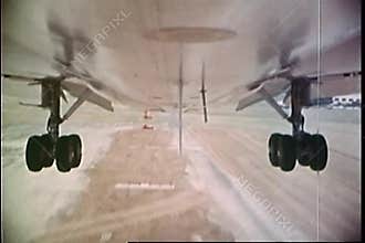 Point of view shot of undercarriage of an airplane landing on runway
