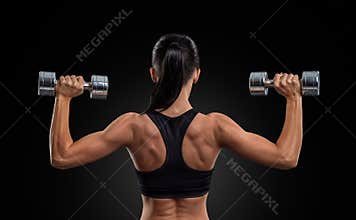 Fitness woman in training muscles of the back with dumbbells