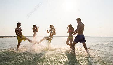 Happy friends having fun on summer beach