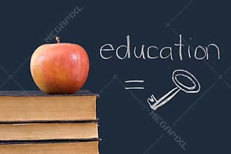 Education = key - written on blackboard with apple