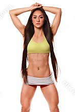 Beautiful athletic woman with long hair posing. Fitness girl showing muscular athletic body, abs. Isolated