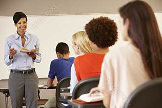 African American teacher teaching at front of class