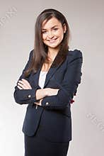 Young happy business woman with cross hands.