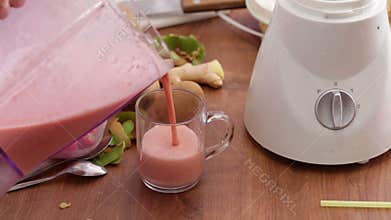 Making strawberry smoothie - filling glass