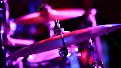 Cymbals on Stage during a Show with really cool lighting.