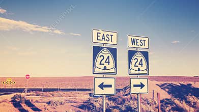Vintage cross processed photo of road signs.