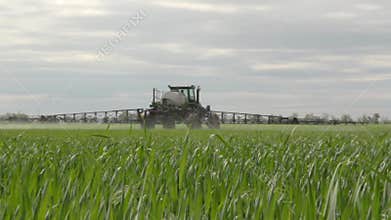 The sprayer sprays young wheat