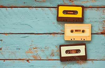 Cassette tapes over blue textured wooden table . top view. retro filter