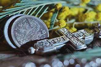 Antique silver coins with the double-headed eagle and an Orthodox cross. Vintage still life