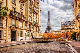 Eiffel Tower seen from the street in Paris, France. Cobblestone pavement