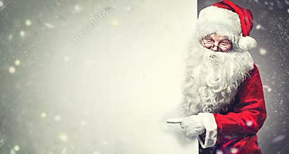 Santa Claus pointing on blank advertisement banner background with copy space