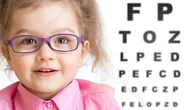 Smiling girl putting on glasses with blurry eye