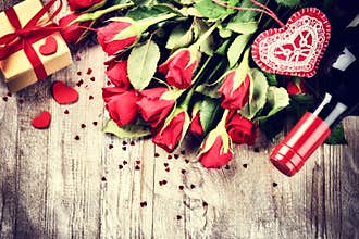 St Valentine's setting with red roses bouquet, present and red w