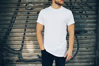 Young man wearing white blank t-shirt and blue