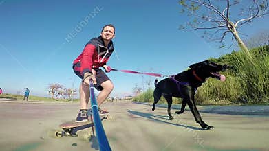 Man on longboard with dog