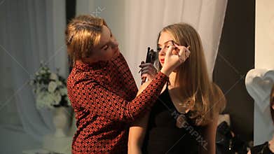 Make up artist paints brows