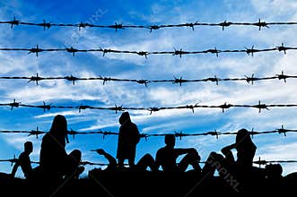 Silhouette crowd of refugees rest on ground