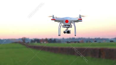 Modern RC UAV Drone / Quadcopter with camera flying on a clear s