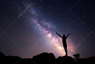 Milky Way. Night sky with stars and silhouette of a woman