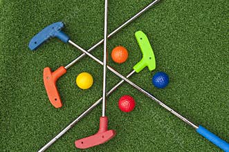 Four Mini Golf Putters and Balls
