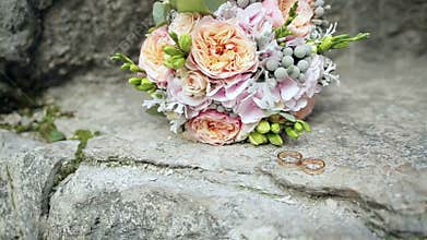 Wedding rings and wedding bouquet.