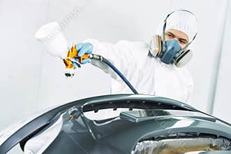 Worker painting auto car bumper