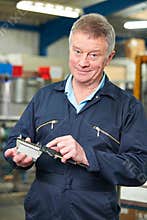 Engineer Measuring Component With Micrometer