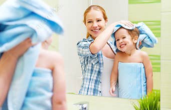 Happy family in bathroom. mother of a child with towel dry hair