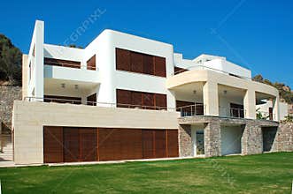 Modern Luxury Villa with Stone and Wood Accents Under Clear Blue Sky