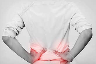 Young man in casual office shirt having hip pain