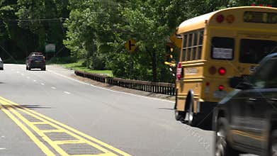 School bus and cars driving by