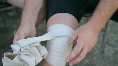 Athlete athletic relieve knee bandages after the competition