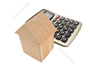 House of wooden building blocks with calculator