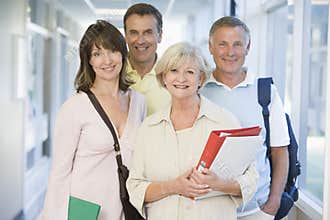 A group of adult students standing in a corridor