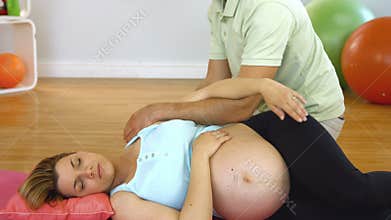 Instructor massaging the pregnant patient