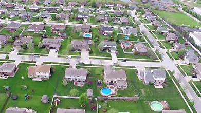 Flying over residential houses and yards along suburban street - Travel and leisure concept