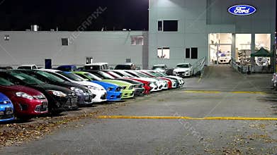 Ford automobile dealership at night scene