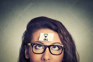 Time management. young woman with sand clock sign