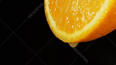 SLOW: A juice drops falls from an orange