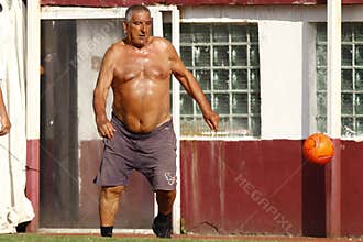 Fat man playing football