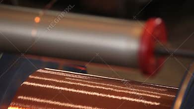 Bare bright copper wire on the spool. Close up