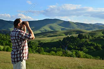 Man with Binoculars on Summer Day