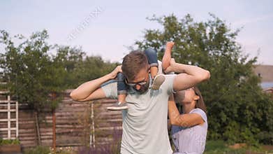 Happy Young Family Having Fun Outdoors. Mom, Dad and Kid Walking, Enjoying Nature Outside.