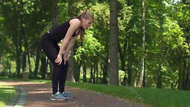 Fitness woman resting after running marathon. Tired girl after workout outdoor