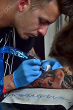 Tattoo artist in work